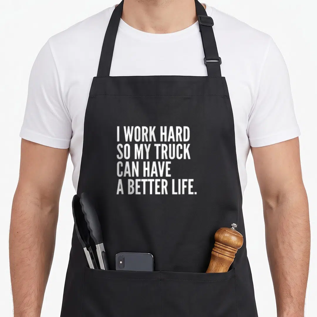 Owner truck apron - White stacked text reading I WORK HARD SO MY TRUCK CAN HAVE A BETTER LIFE — shown on a black cotton canvas apron against a white background