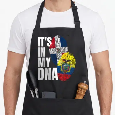 Ecuadorian dominican heritage aprons - IT'S IN MY DNA text beside two fingerprints filled with Dominican and Ecuadorian — shown on a black cotton canvas apron against a white background