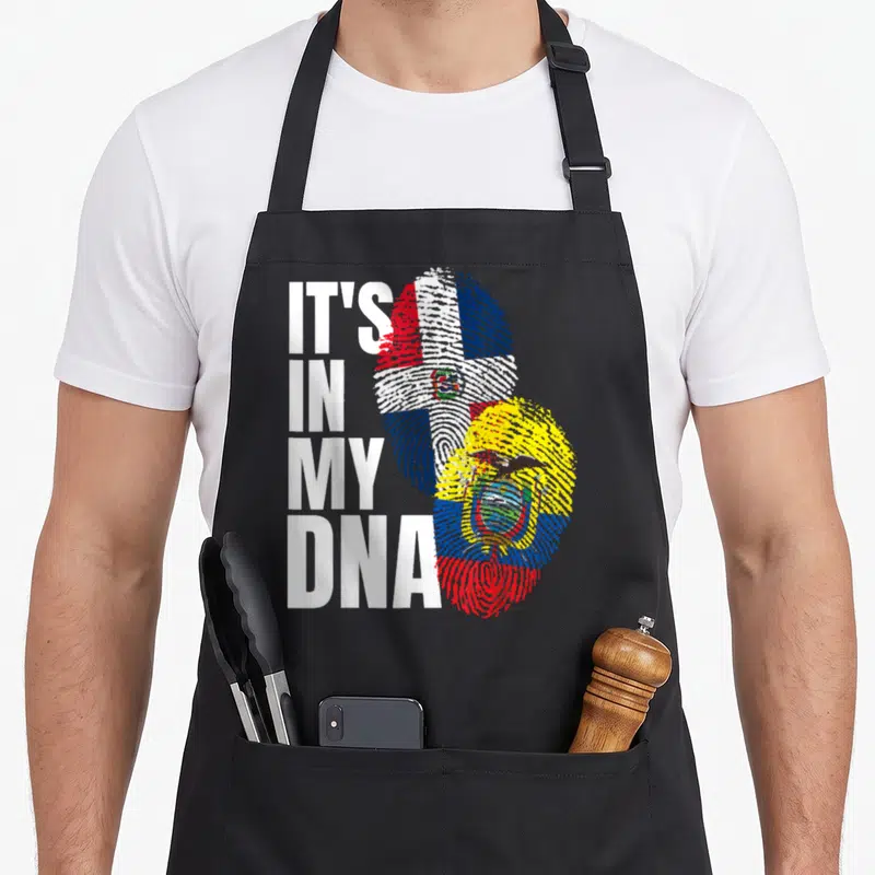 Ecuadorian dominican heritage aprons - IT'S IN MY DNA text beside two fingerprints filled with Dominican and Ecuadorian — shown on a black cotton canvas apron against a white background
