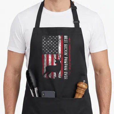 Deer father day apron - Best Buckin Pawpaw Ever text beside deer silhouette on distressed flag — shown on a black cotton canvas apron against a white background