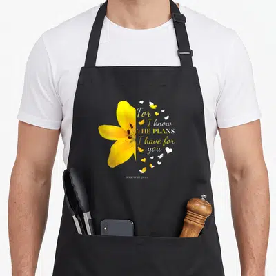 Religious flower bible verse apron - Yellow lily photo next to Jeremiah 29:11 text with butterflies and hearts — shown on a black cotton canvas apron against a white background