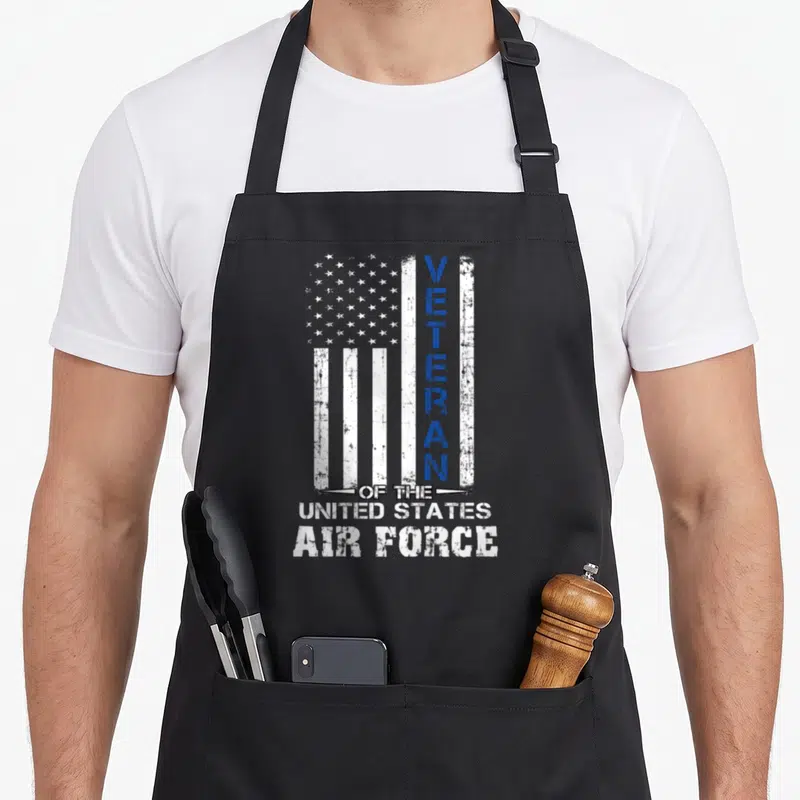 State air us aprons - Distressed US flag with vertical VETERAN text and stacked United States Air Force lettering — shown on a black cotton canvas apron against a white background