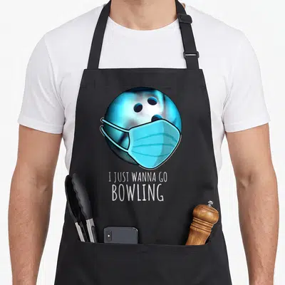 Funny bowling player apron - Blue bowling ball wearing light blue surgical mask above white stacked text — shown on a black cotton canvas apron against a white background