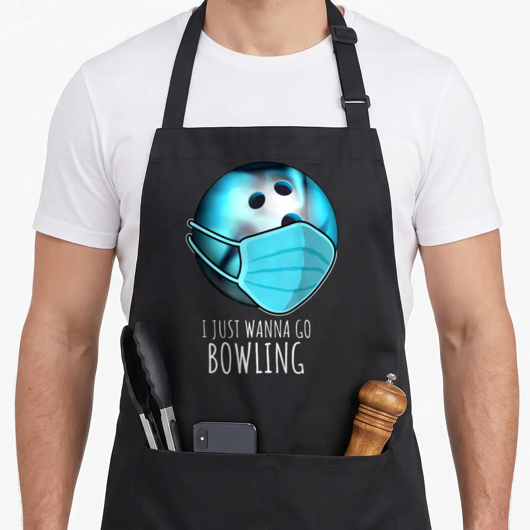 Funny bowling player apron - Blue bowling ball wearing light blue surgical mask above white stacked text — shown on a black cotton canvas apron against a white background
