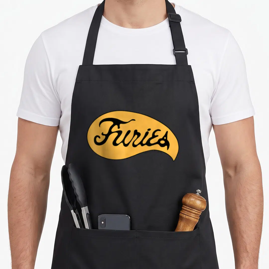 Fury warrior apron - Black script reading Furies inside a yellow organic oval with a black border — shown on a black cotton canvas apron against a white background