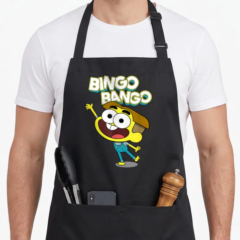 Channel cricket apron - BINGO BANGO text above a waving yellow cartoon character in blue overalls — shown on a black cotton canvas apron against a white background