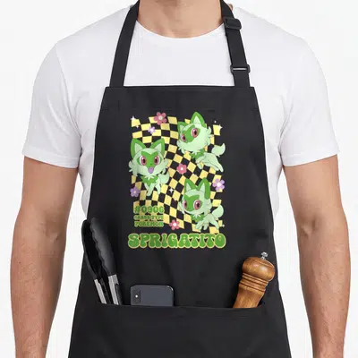 Pok video game apron - Three Sprigatito on yellow checkerboard with #0906 Grass Type text — shown on a black cotton canvas apron against a white background
