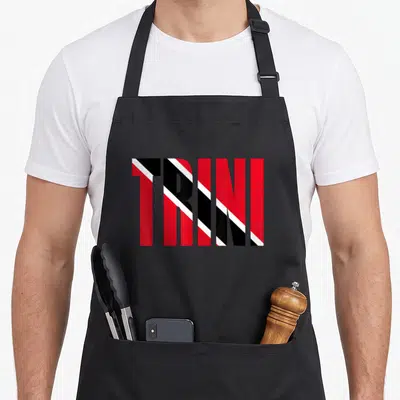 Flagcastle trinidadian apron - TRINI text filled with red black and white diagonal stripes — shown on a black cotton canvas apron against a white background
