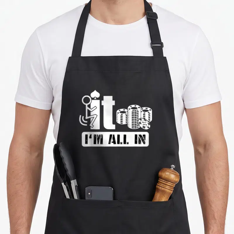 Poker casino aprons - Wheelchair figure on letter i next to chip stacks above I'M ALL IN text — shown on a black cotton canvas apron against a white background