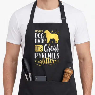Pyrenee glitter dog apron - Yellow dog silhouette with It's Not Dog Hair It's Great Pyrenees Glitter text and stars — shown on a black cotton canvas apron against a white background