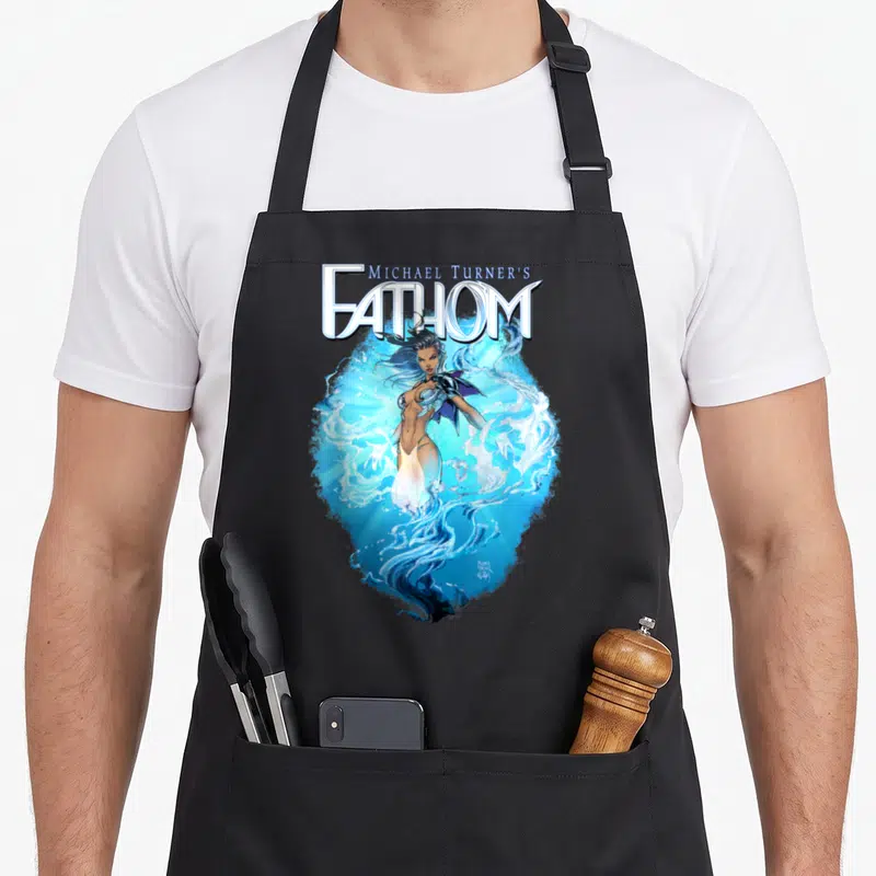 Swimsuit aspen apron - Michael Turner's FATHOM logo above blue-haired woman in swirling blue and white water — shown on a black cotton canvas apron against a white background