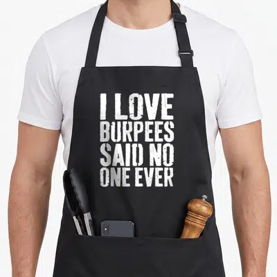 Gym workout burpees apron - White stacked text reading I Love Burpees Said No One Ever in distressed font — shown on a black cotton canvas apron against a white background