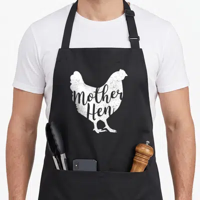 Mother chicken hen apron - White hen silhouette with grey mother Hen text overlay — shown on a black cotton canvas apron against a white background