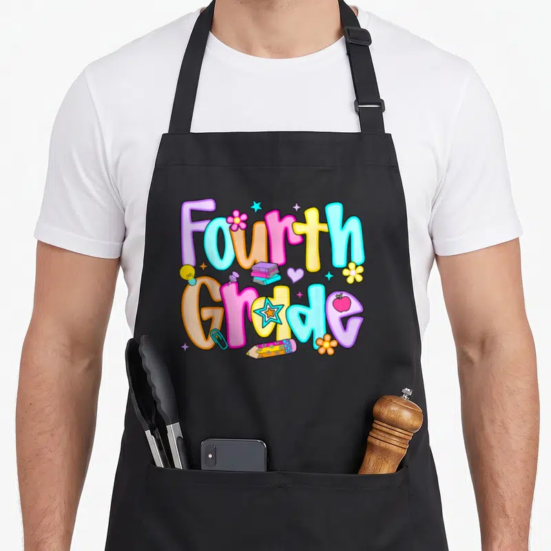 Preppy teacher apron - Colorful Fourth Grade bubble letters with books, pencil, and apple icons — shown on a black cotton canvas apron against a white background