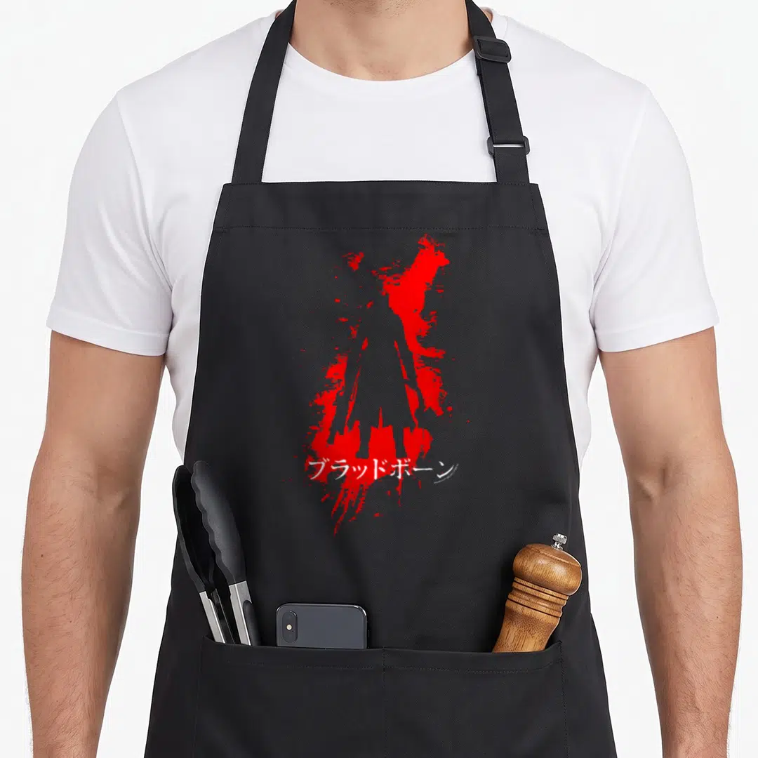 Bloodborne video game apron - Red silhouette of a figure surrounded by splatter with white Japanese text across — shown on a black cotton canvas apron against a white background