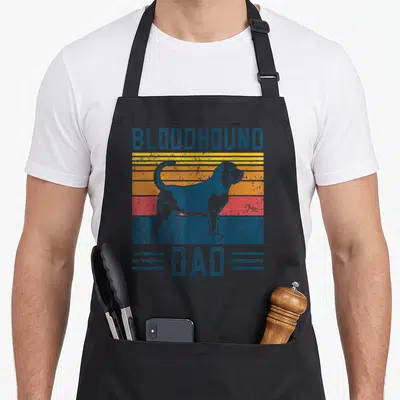 Cool bloodhound dog apron - Retro bloodhound silhouette over blue yellow orange and red stripes with dad text — shown on a black cotton canvas apron against a white background