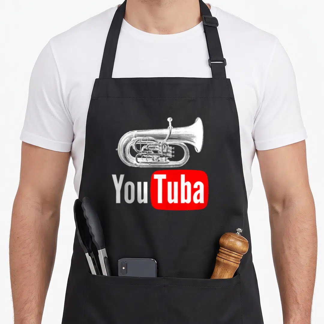 Marching tuba apron - White tuba illustration above You Tuba text next to red rectangle — shown on a black cotton canvas apron against a white background