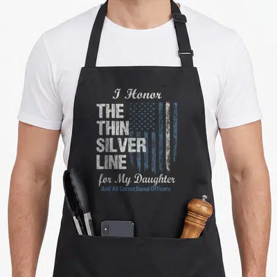 Correctional line apron - Distressed flag with I Honor THE THIN SILVER LINE for My Daughter text in white and blue-grey — shown on a black cotton canvas apron against a white background