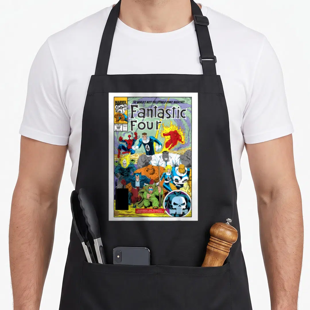 Exclusive cover apron - Fantastic Four comic cover with skull cameo logo and $1.00 US price tag in blue red yellow — shown on a black cotton canvas apron against a white background