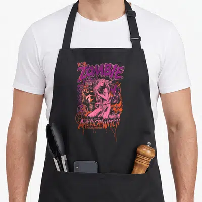 Rob witch apron - Rob Zombie American Witch woman pentagram skull distressed purple pink orange text — shown on a black cotton canvas apron against a white background