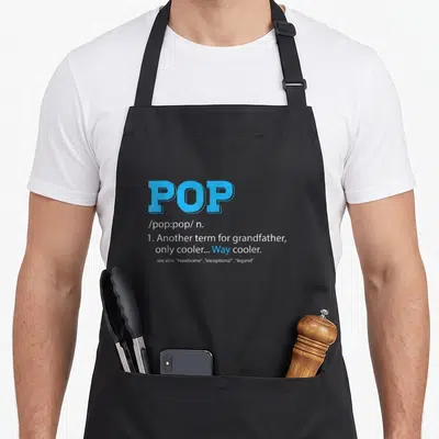 Definition grandpa apron - Blue and white dictionary definition text reading POP another term for grandfather way cooler — shown on a black cotton canvas apron against a white background