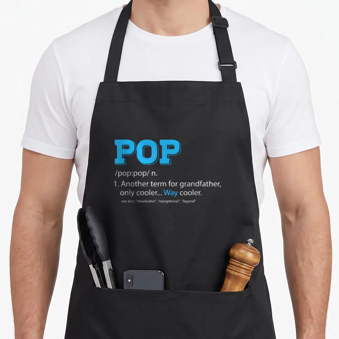 Definition grandpa apron - Blue and white dictionary definition text reading POP another term for grandfather way cooler — shown on a black cotton canvas apron against a white background