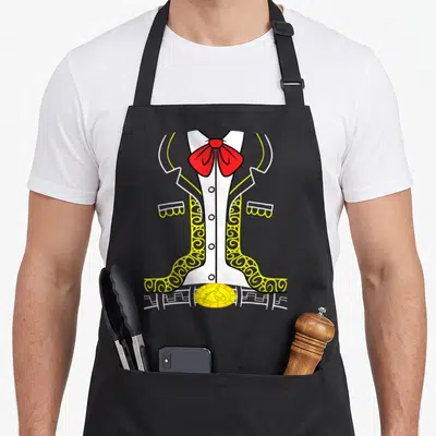 Charro mexican apron - Cartoon charro suit with red bow tie and gold horse-buckle belt in white yellow red — shown on a black cotton canvas apron against a white background