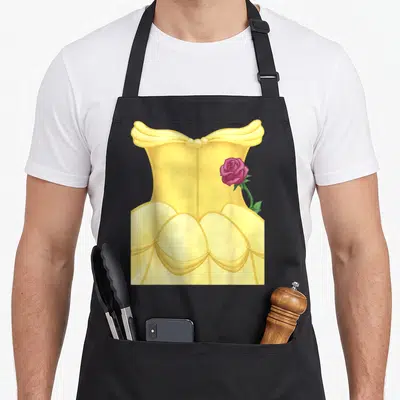 Beauty halloween white apron - Yellow ballgown with pink rose and green leaf cartoon art — shown on a black cotton canvas apron against a white background