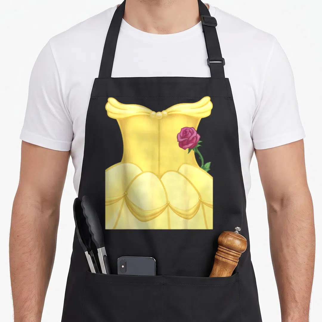 Beauty halloween white apron - Yellow ballgown with pink rose and green leaf cartoon art — shown on a black cotton canvas apron against a white background