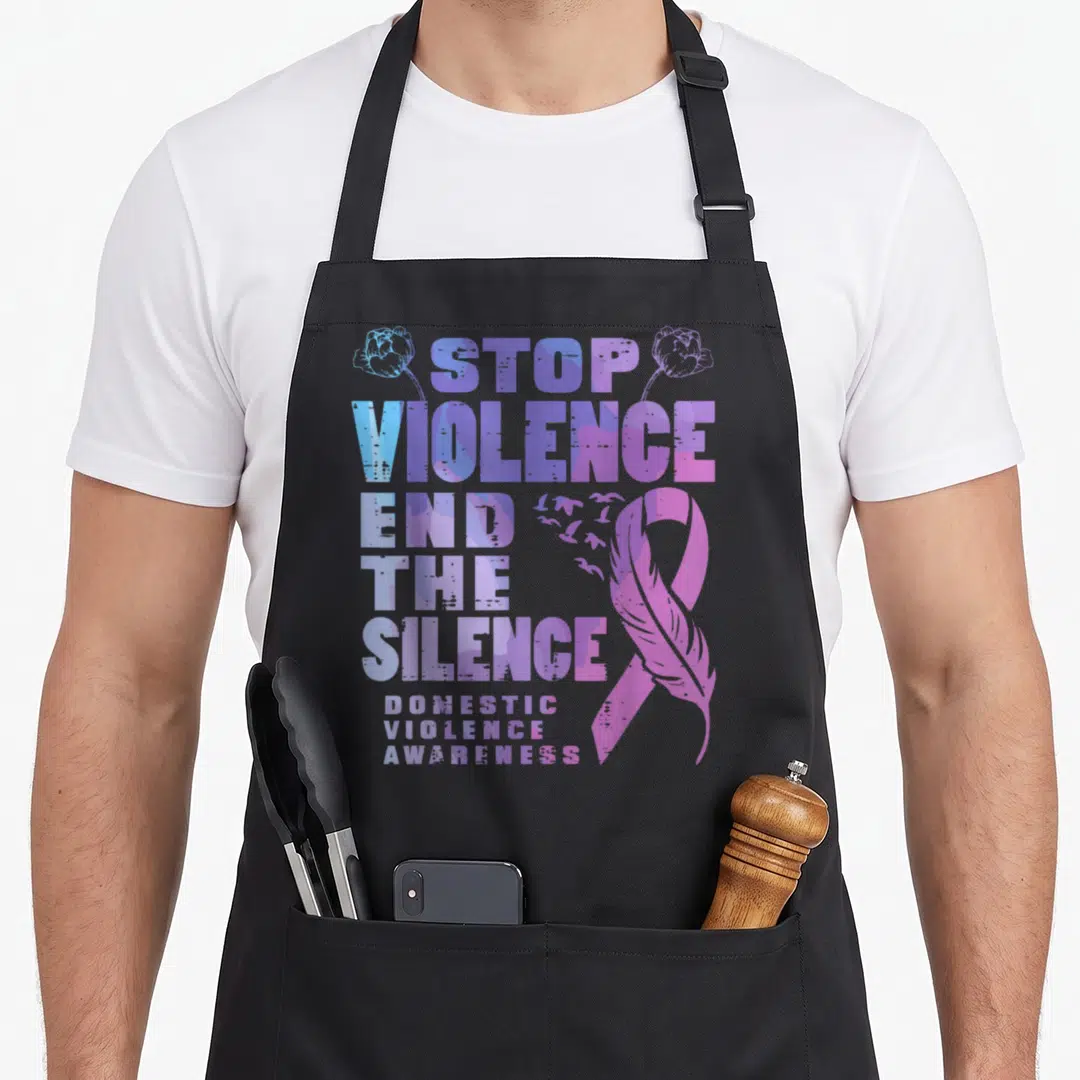 End domestic aprons - Stacked text Stop Violence End Silence with purple ribbon feather and birds — shown on a black cotton canvas apron against a white background