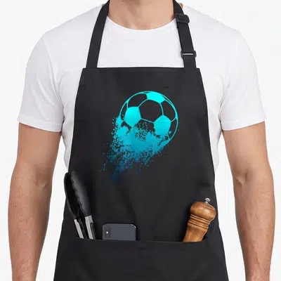 Player soccer apron - Cyan soccer ball with paint splatter effect on black apron — shown on a black cotton canvas apron against a white background