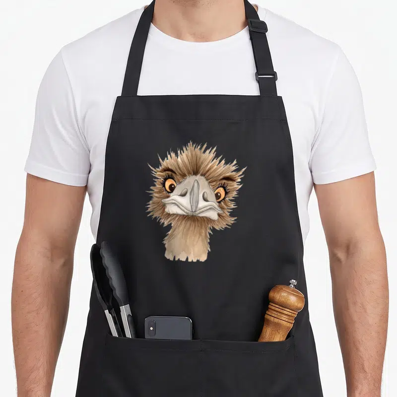 Emus i love my emu apron - Watercolor illustration of an ostrich head with brown feathers and orange eyes on a plain — shown on a black cotton canvas apron against a white background