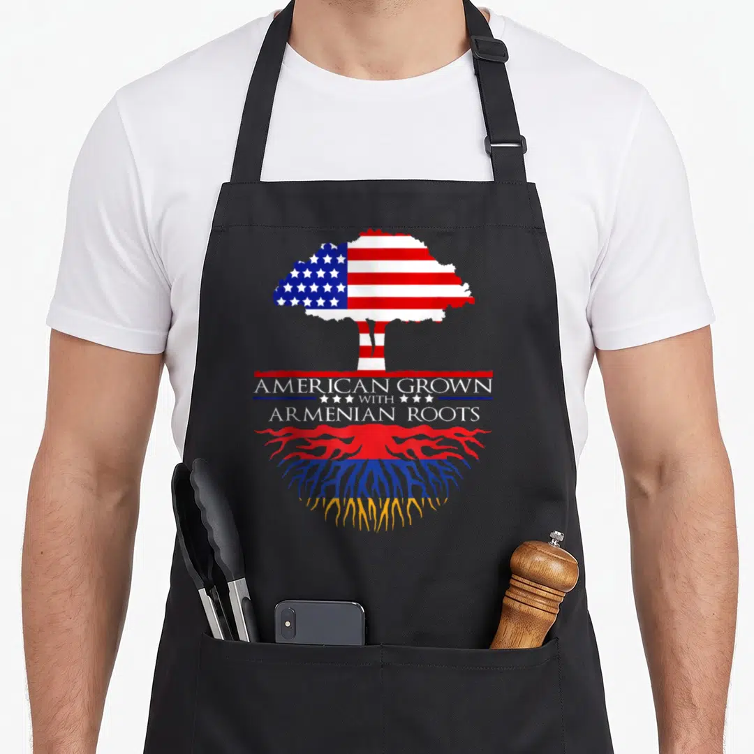Armenian root american flag apron - Tree with US flag canopy and Armenian flag roots and stacked text — shown on a black cotton canvas apron against a white background
