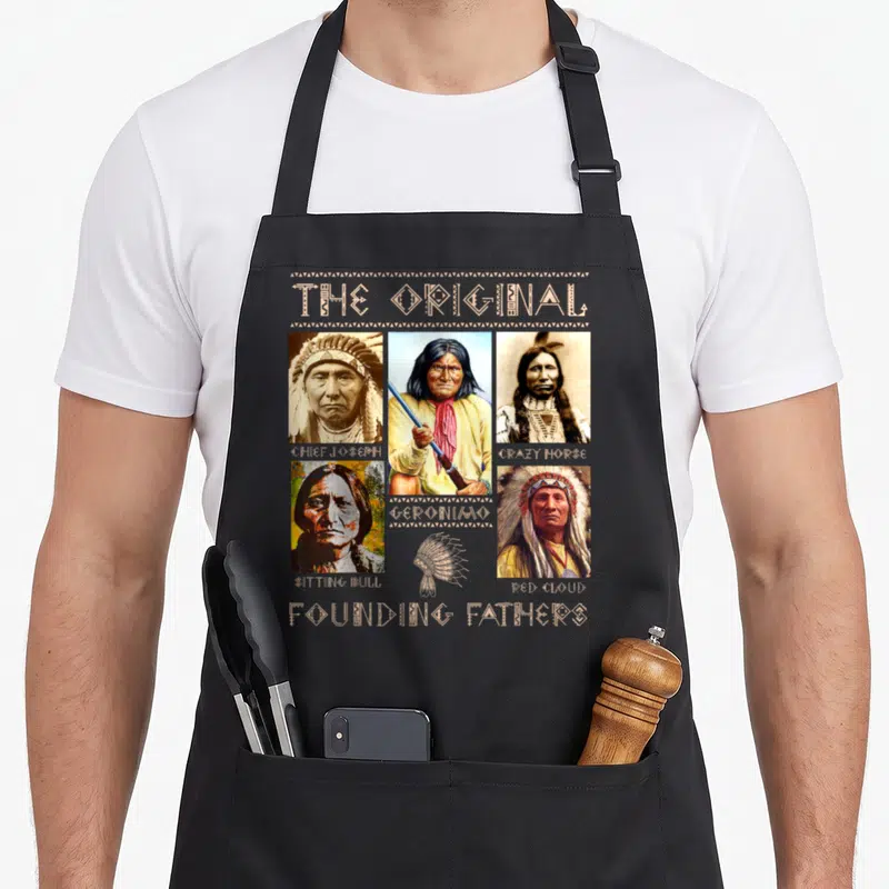 Founding native american apron - Five portraits of Native leaders labeled The Original Founding Fathers in beige — shown on a black cotton canvas apron against a white background