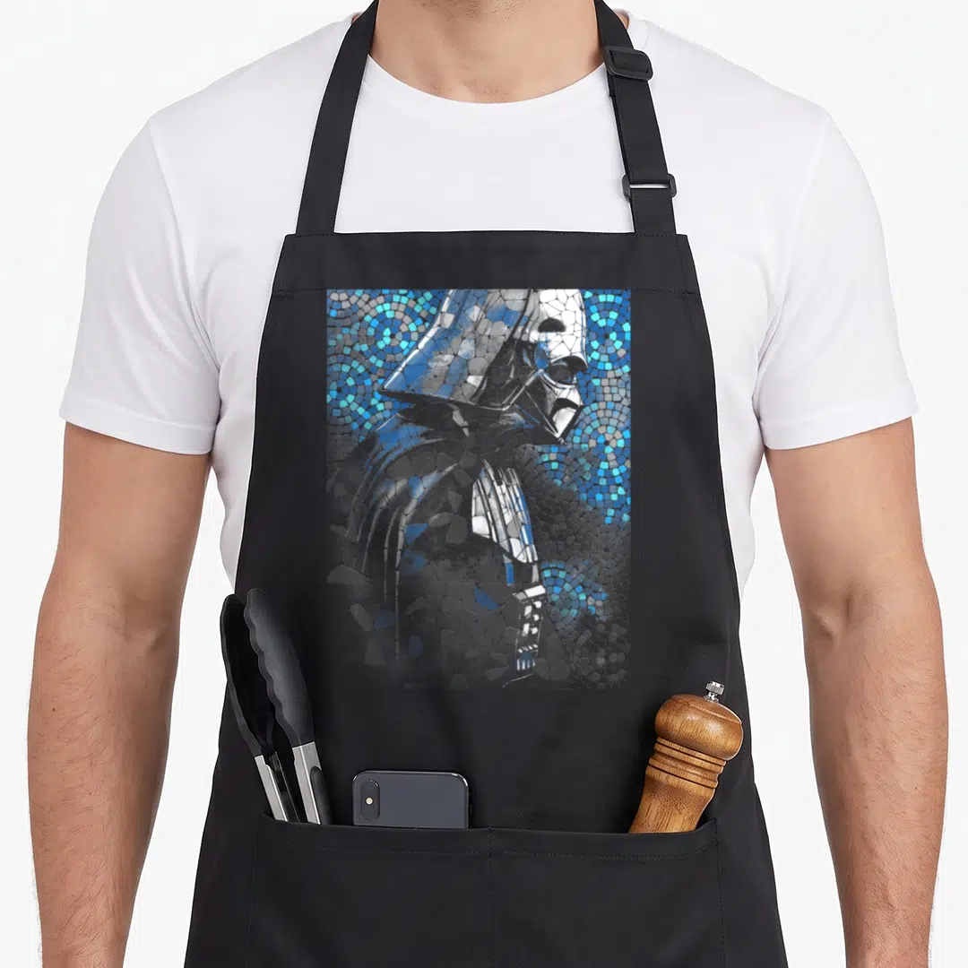 Mosaic general apron - Mosaic portrait of a stormtrooper formed by blue, grey, and white tiles — shown on a black cotton canvas apron against a white background