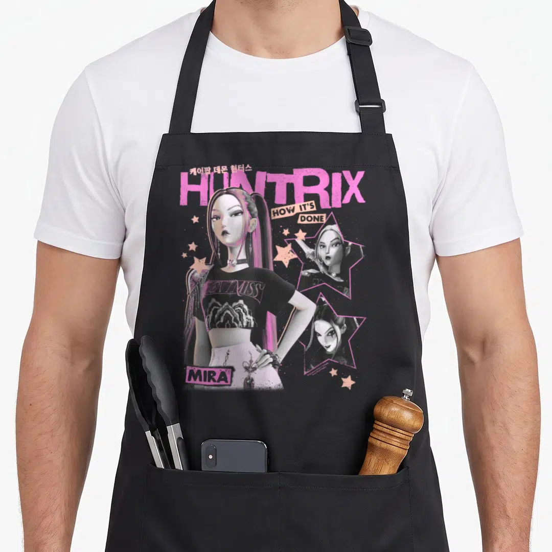 Mira y2k trend apron - Mira character art with Huntrix text and pink stars on black apron — shown on a black cotton canvas apron against a white background