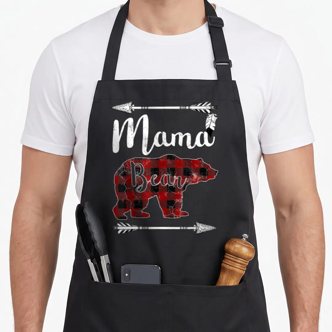 Buffalo mother's day aprons - Mama Bear text over red black plaid bear silhouette flanked by arrows — shown on a black cotton canvas apron against a white background