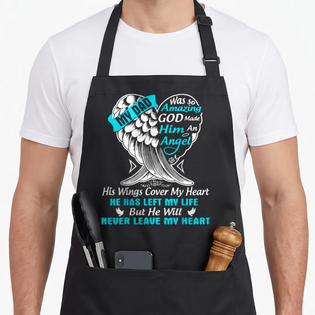 Amazing angels in aprons - Cyan ribbon and white angel wing forming a heart with memorial text about a dad — shown on a black cotton canvas apron against a white background