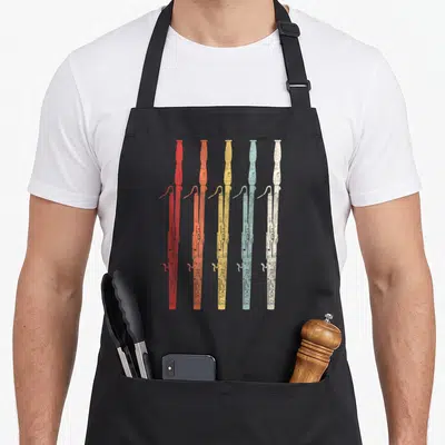 Bassoon 70s apron - Five rifles in red orange yellow light blue and white distressed vertical row — shown on a black cotton canvas apron against a white background