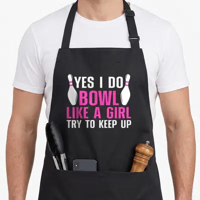 Bowling show mama apron - Stacked white and pink text YES I DO BOWL LIKE A GIRL TRY TO KEEP UP flanked by two white — shown on a black cotton canvas apron against a white background