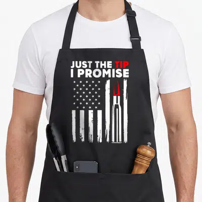 Tip bullet addict apron - Distressed US flag with a bullet replacing a stripe and text JUST THE TIP I PROMISE — shown on a black cotton canvas apron against a white background