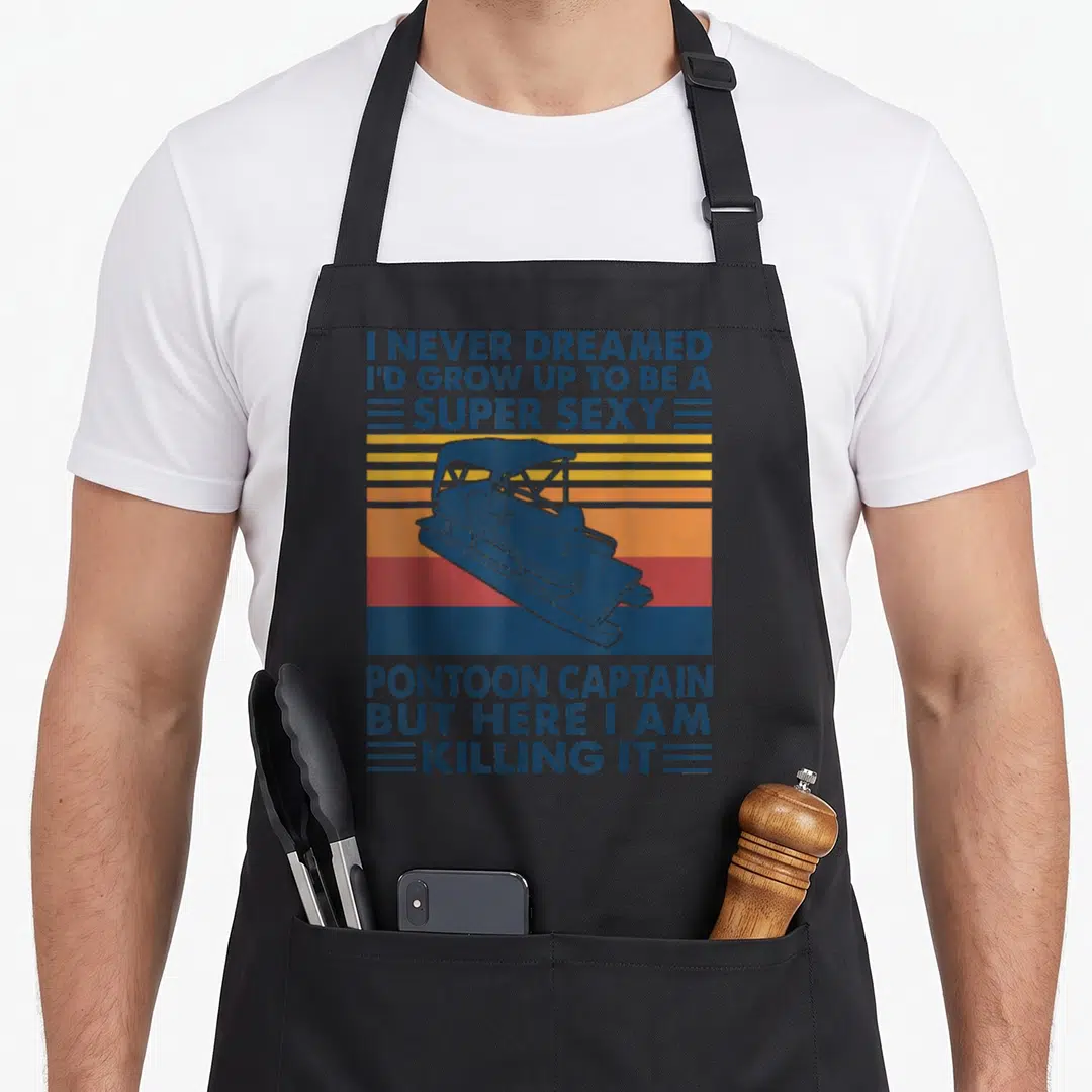 Grow pontoon apron - Retro blue pontoon boat over yellow orange red stripes with sarcastic captain quote text — shown on a black cotton canvas apron against a white background