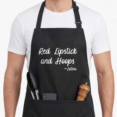 Lipstick latin apron - White cursive text Red Lipstick and Hoops -Latina stacked vertically — shown on a black cotton canvas apron against a white background