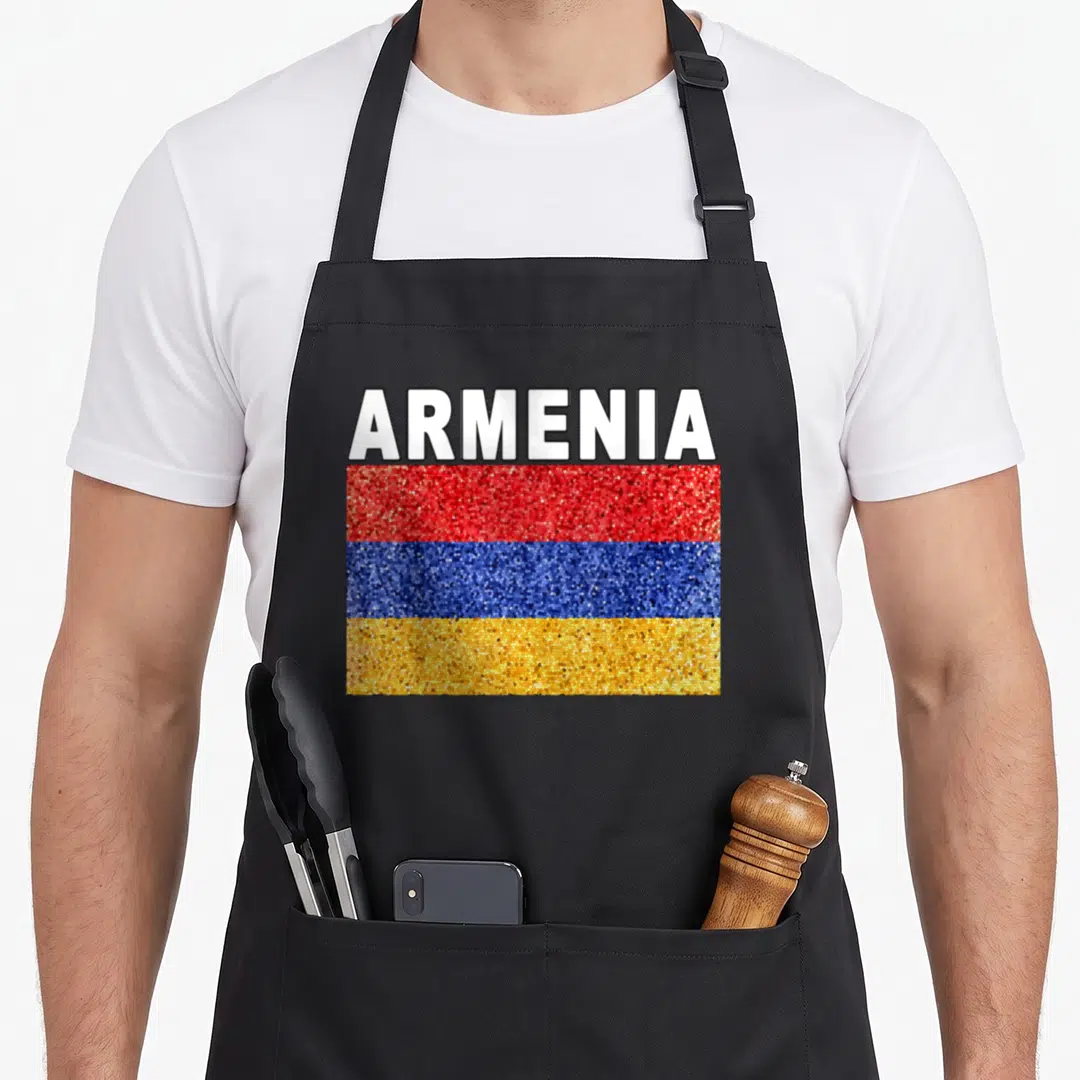 Armenia artistic apron - White ARMENIA text above red blue orange mosaic flag rectangle — shown on a black cotton canvas apron against a white background