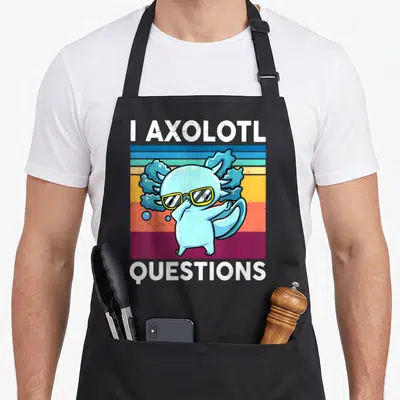 Question salamander apron - Blue axolotl wearing yellow glasses on striped background with text I AXOLOTL QUESTIONS — shown on a black cotton canvas apron against a white background