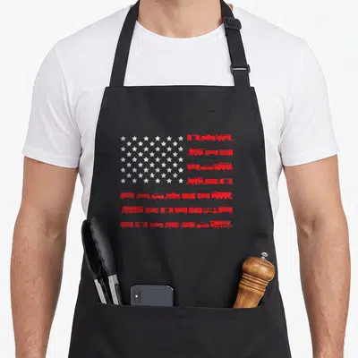 Railroad american flag apron - Distressed USA flag design with red train car stripes and white stars — shown on a black cotton canvas apron against a white background