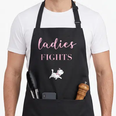 Aristocat novelty apron - Cartoon white cat with pink bow below pink and grey text saying ladies don't start fights — shown on a black cotton canvas apron against a white background