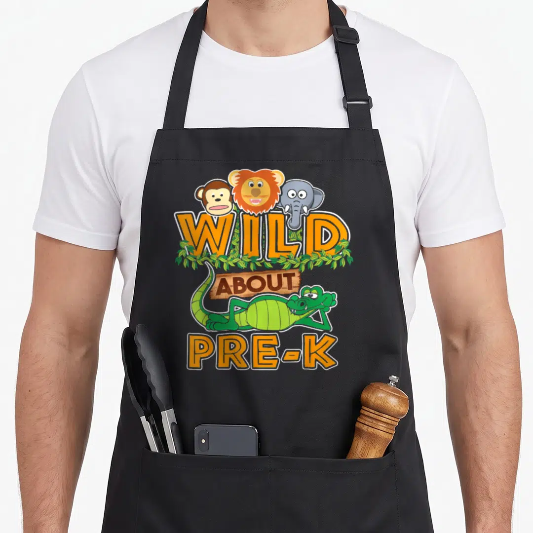 Wild pre classroom aprons - Cartoon monkey lion elephant and alligator surrounding Wild About Pre-K text in orange — shown on a black cotton canvas apron against a white background