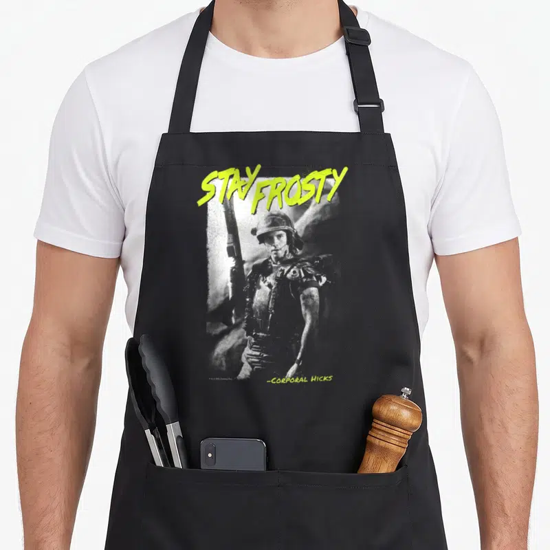 Alien frosty apron - Stay Frosty text and grey soldier portrait with lime green lettering — shown on a black cotton canvas apron against a white background