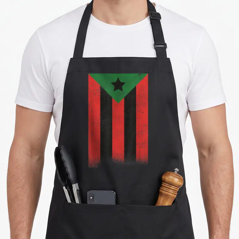 Afro mozambique apron - Distressed red black and green flag with vertical stripes and a star in a green triangle — shown on a black cotton canvas apron against a white background